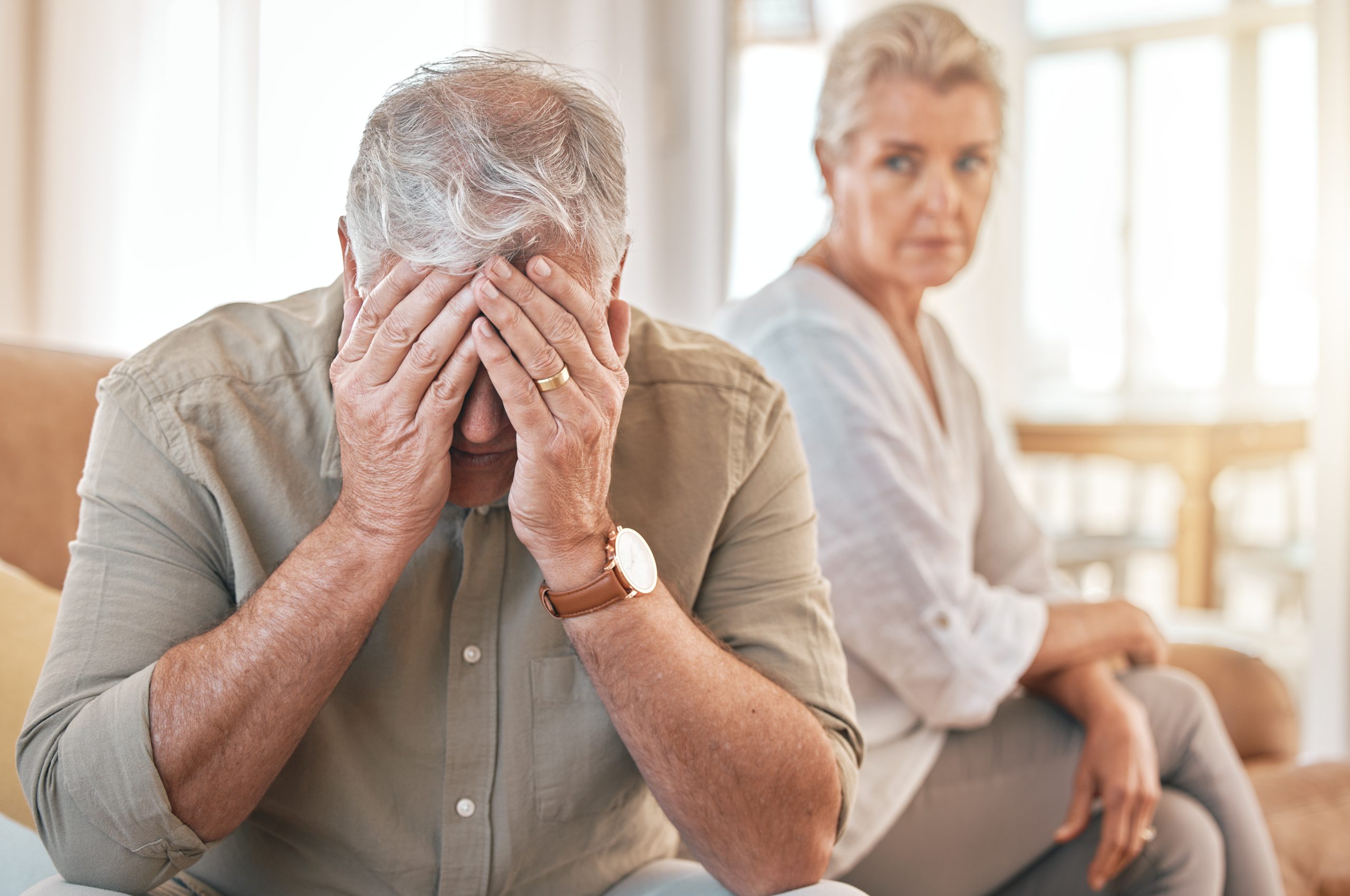 Senior couple, divorce and conflict in fight, argument or disagreement on living room sofa at home. Elderly woman and frustrated man in depression, cheating affair or toxic relationship in the house Disoriented elder experiencing delirium