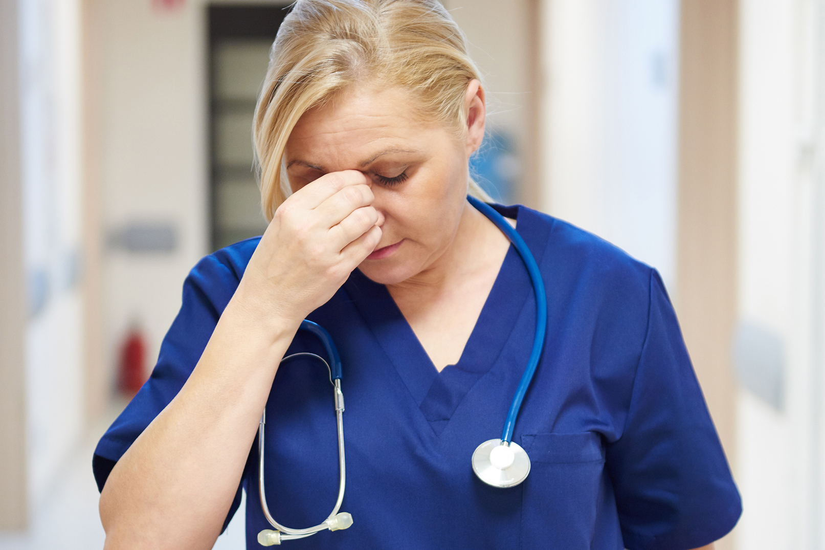 Tired female doctor after long day Caregiver burnout